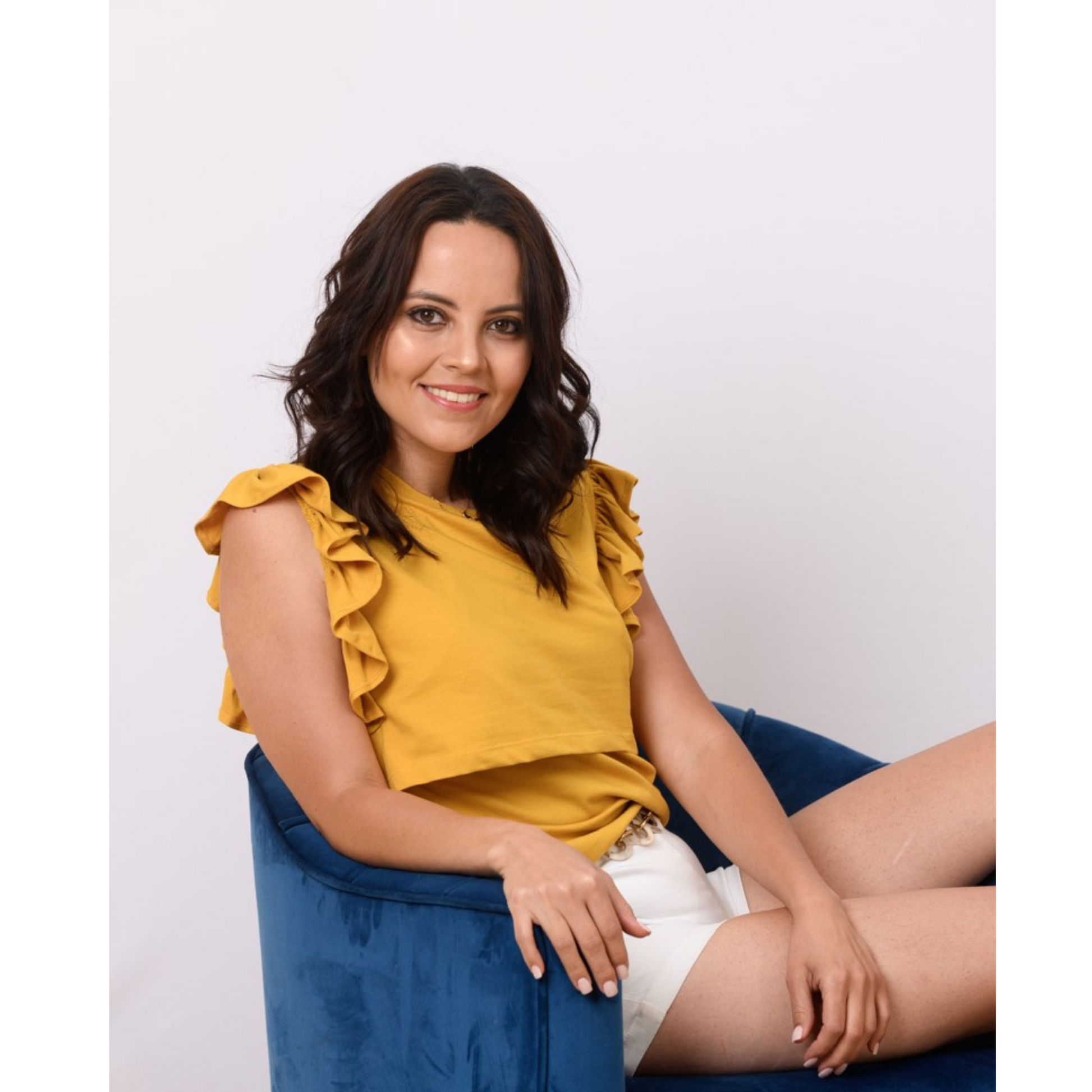 Seated woman wearing yellow breastfeeding nursing top with front-layer nursing access, ruffle sleeves, and postpartum-friendly fit.