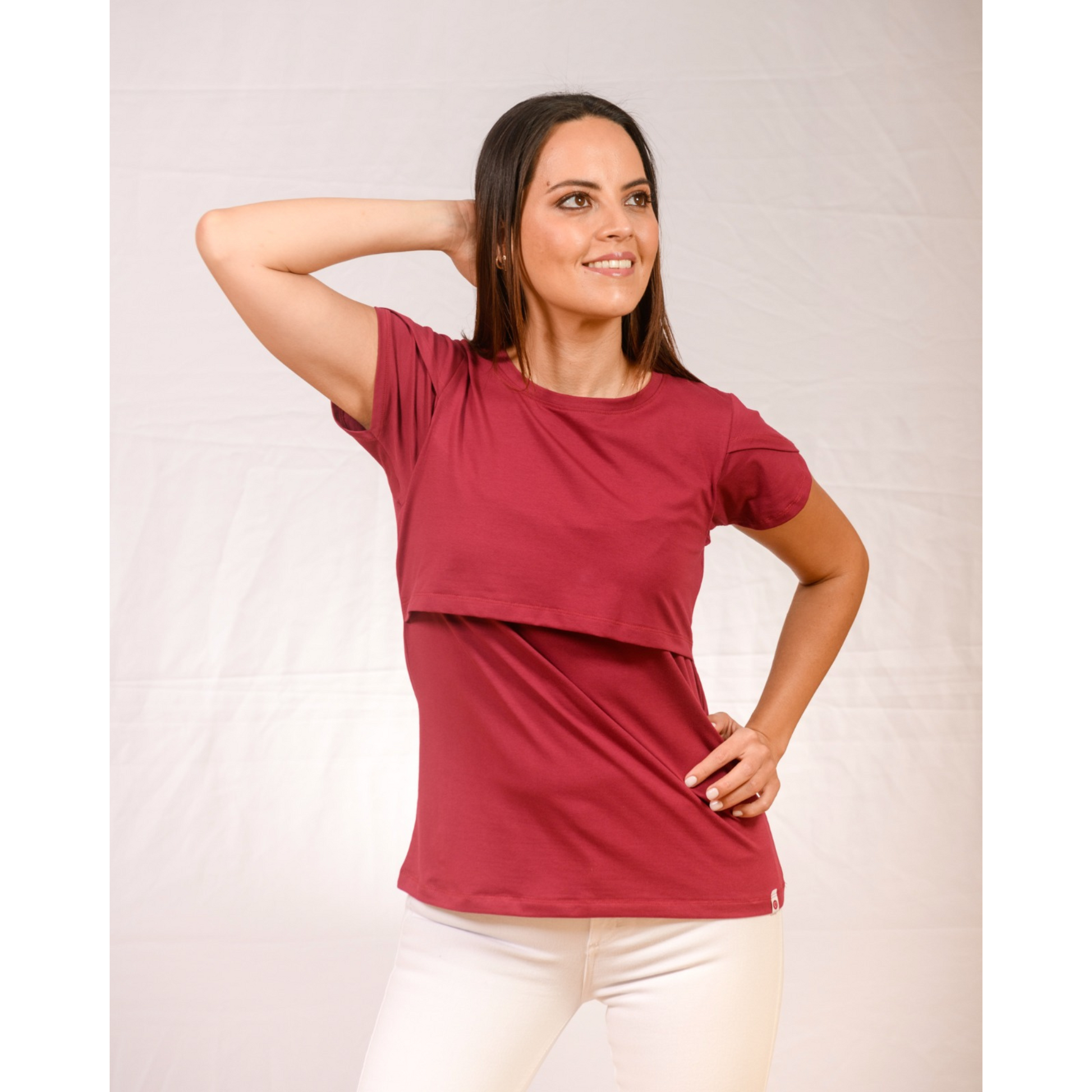 Woman wearing cherry nursing top with front-layer design, short sleeves, and discreet breastfeeding access for postpartum moms.